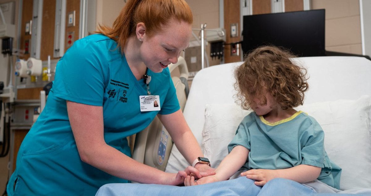 nursing student taking pulse of young girl