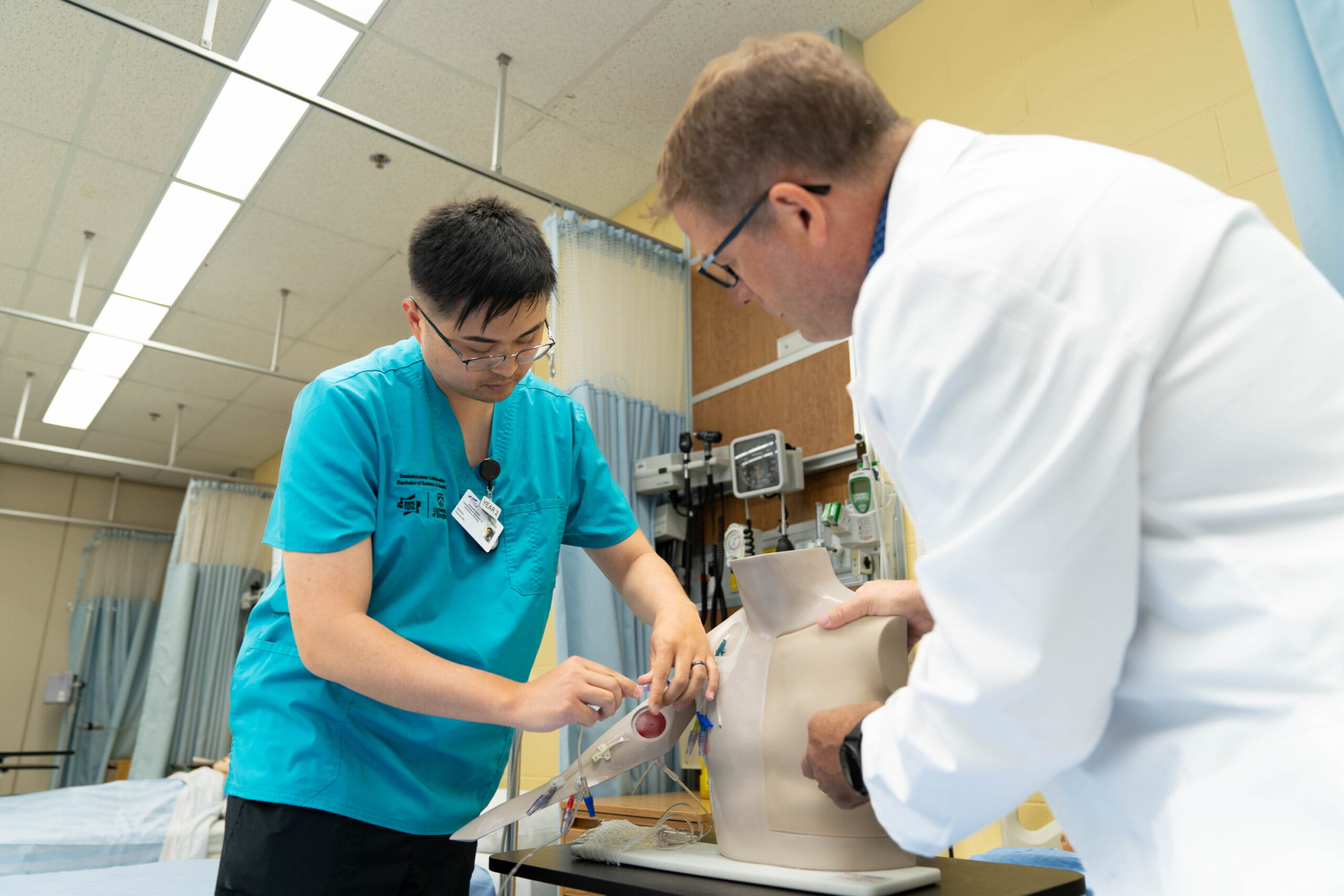 Nursing instructor working with nursing student in the simulation lab